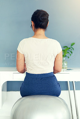 Buy stock photo Rearview shot of a young businesswoman working at home