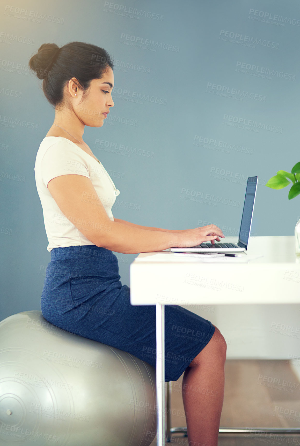 Buy stock photo Cropped shot of a young businesswoman working on her laptop at home