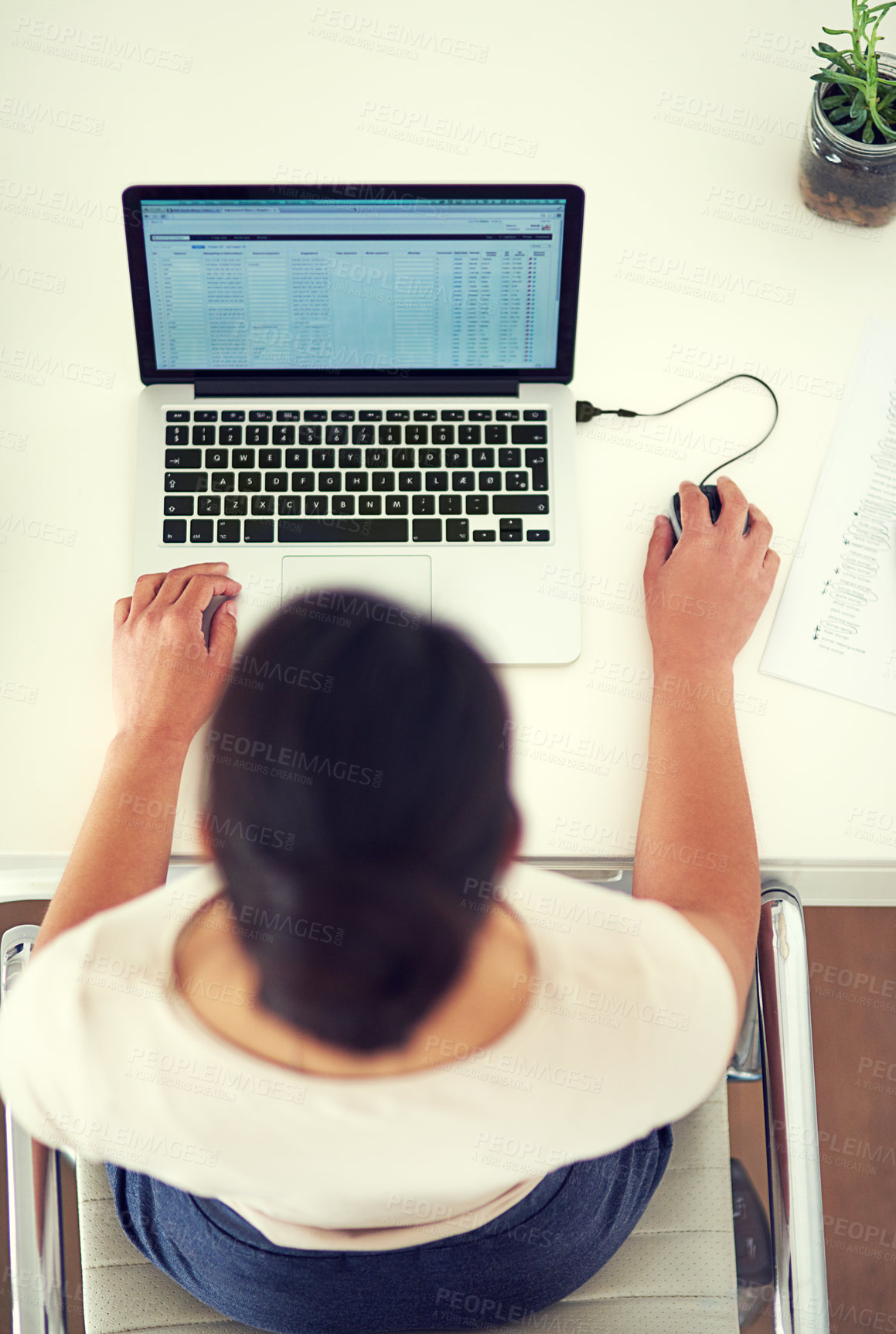 Buy stock photo High angle shot of a young businesswoman working on her laptop at home