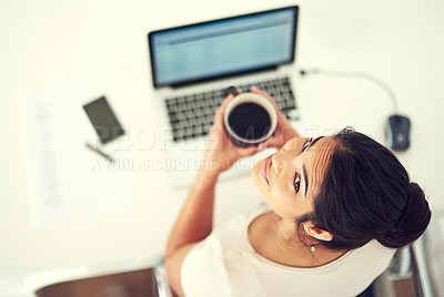 Buy stock photo High angle portrait of a young businesswoman drinking coffee while working at home