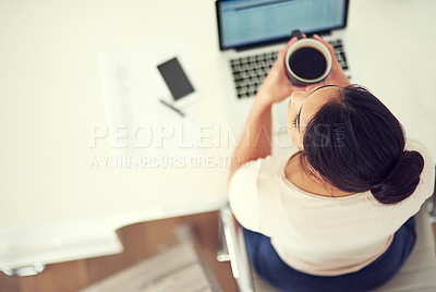 Buy stock photo High angle shot of a young businesswoman working on her laptop at home