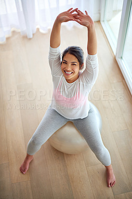 Buy stock photo Top view, portrait and woman with fitness ball, home and exercise for stretching, wellness and balance in lounge. Face, healthy person and girl in living room, training and core workout with cardio