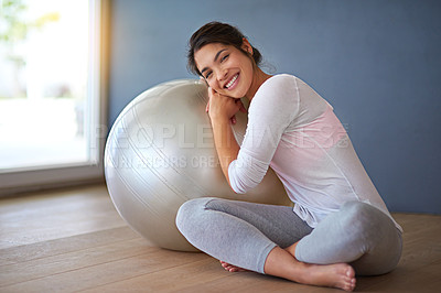 Buy stock photo Health, happy woman and exercise ball in portrait on floor for core workout, balance and weight loss in studio. Yogi, smile and training equipment for fitness, wellness and cardio on grey background