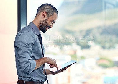 Buy stock photo Cropped shot of a businessman using his tablet in the office