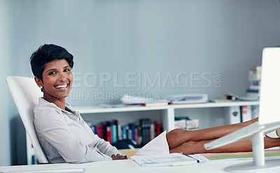 Buy stock photo Portrait of a young businesswoman leaning back in her at her desk