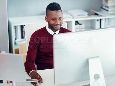 Buy stock photo Shot of a young businessman working at his desk in an office