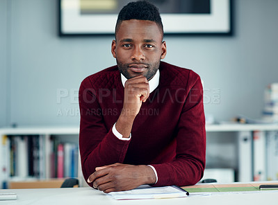 Buy stock photo Portrait of a young businessman sitting at his desk in an office