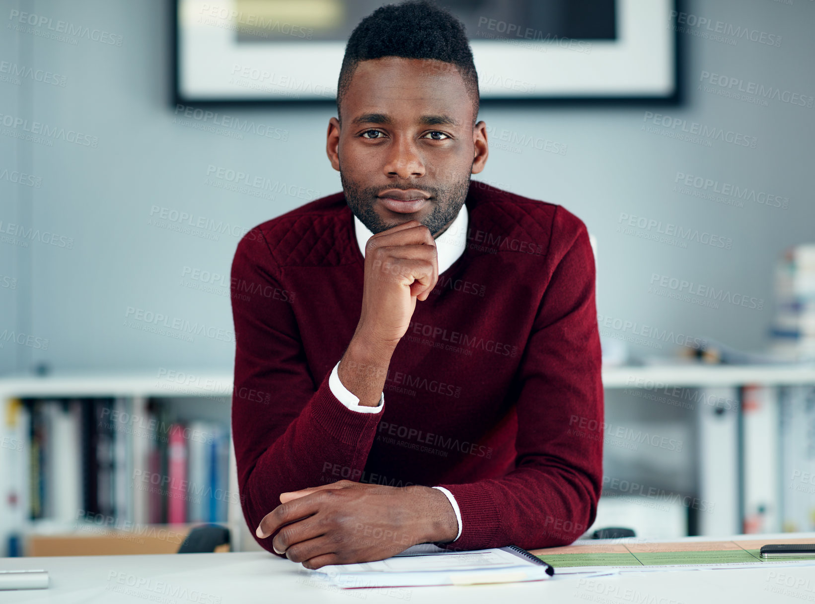 Buy stock photo Portrait of a young businessman sitting at his desk in an office