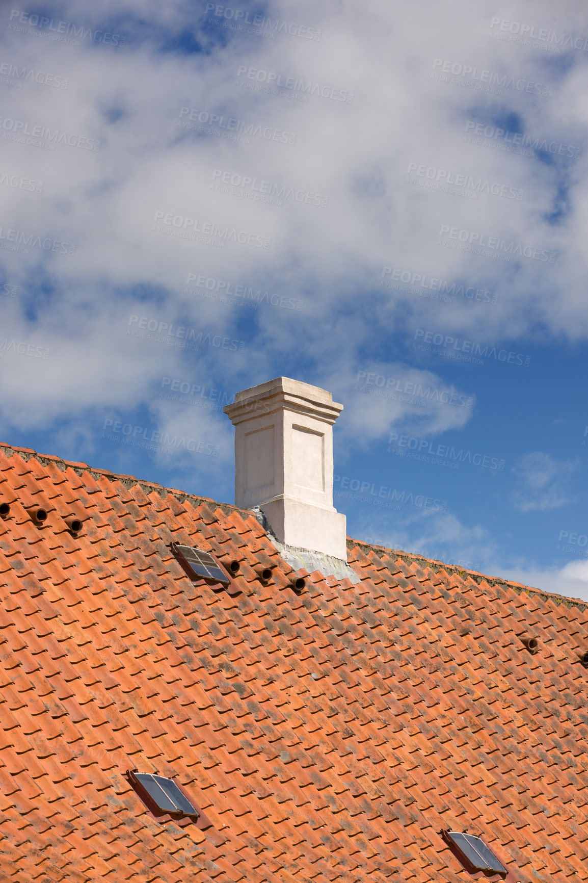 Buy stock photo Chimney designed on slate roof of house building outside against blue sky with white clouds background. Construction of exterior escape chute built on rooftop for fireplace smoke and heat from below