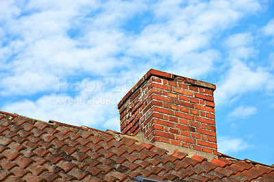 Buy stock photo Red brick chimney designed on slate roof of house building outside against blue sky with white clouds background. Construction frame of escape chute built on rooftop for smoke and heat from fireplace