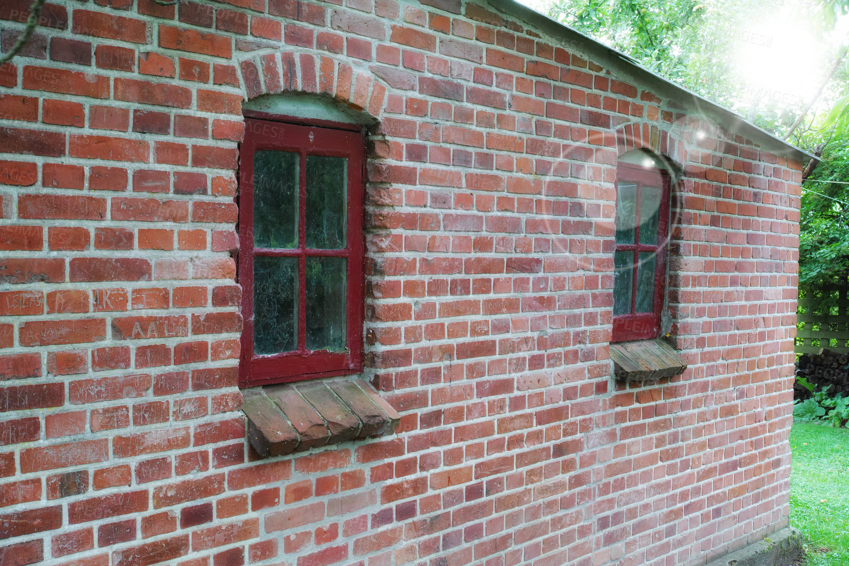 Buy stock photo Old windows on an old red brick wall of a house or home. Glass with metal red frames on historic church building and background. Architecture design on a city structure outside with copyspace