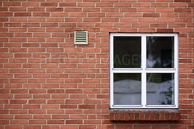 Buy stock photo View of a square window on an old red brick wall of a house or home. Glass with metal frame on historic church building and background. Architecture design on a city structure outside with copyspace