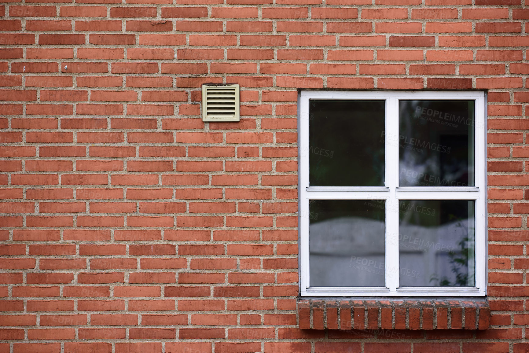 Buy stock photo View of a square window on an old red brick wall of a house or home. Glass with metal frame on historic church building and background. Architecture design on a city structure outside with copyspace