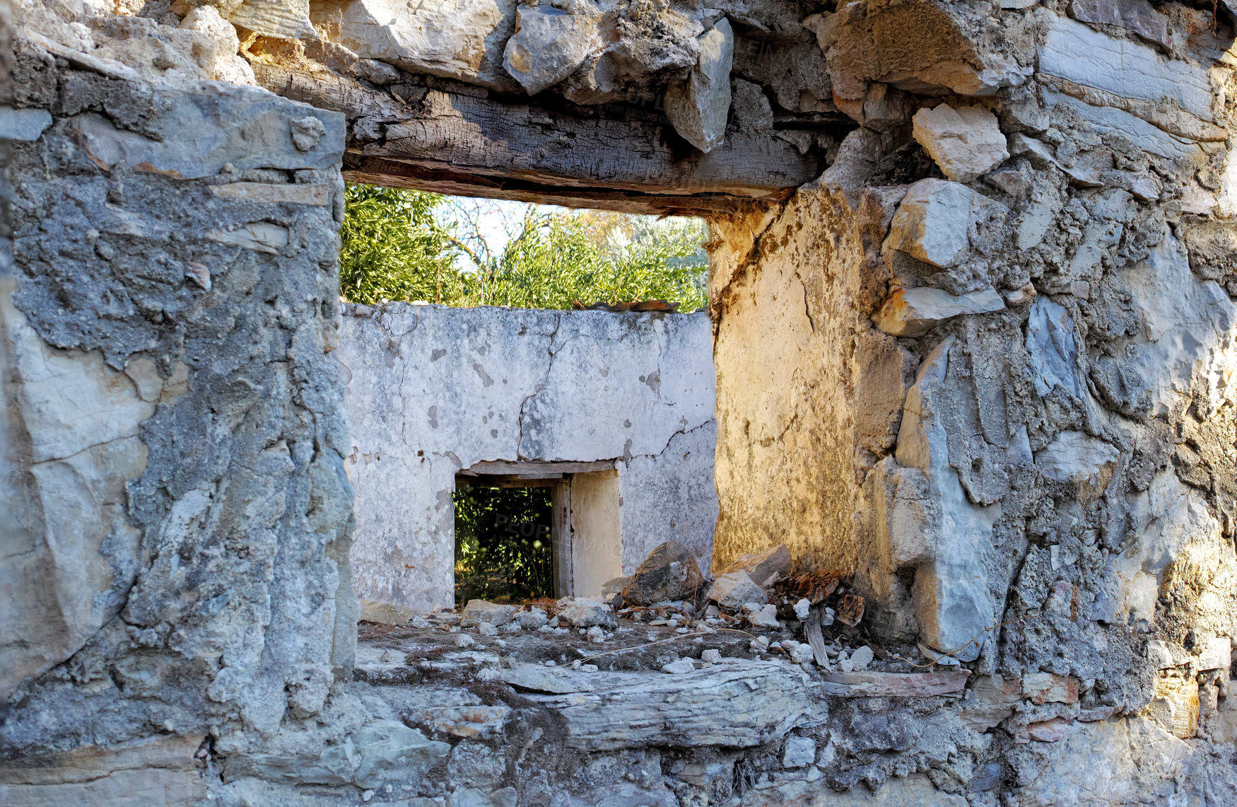 Buy stock photo Abandoned old broken house with thick crumbling stone walls. Ruins of damaged rural home with an empty window frame. Weathered antique farmhouse with traditional architecture and building design