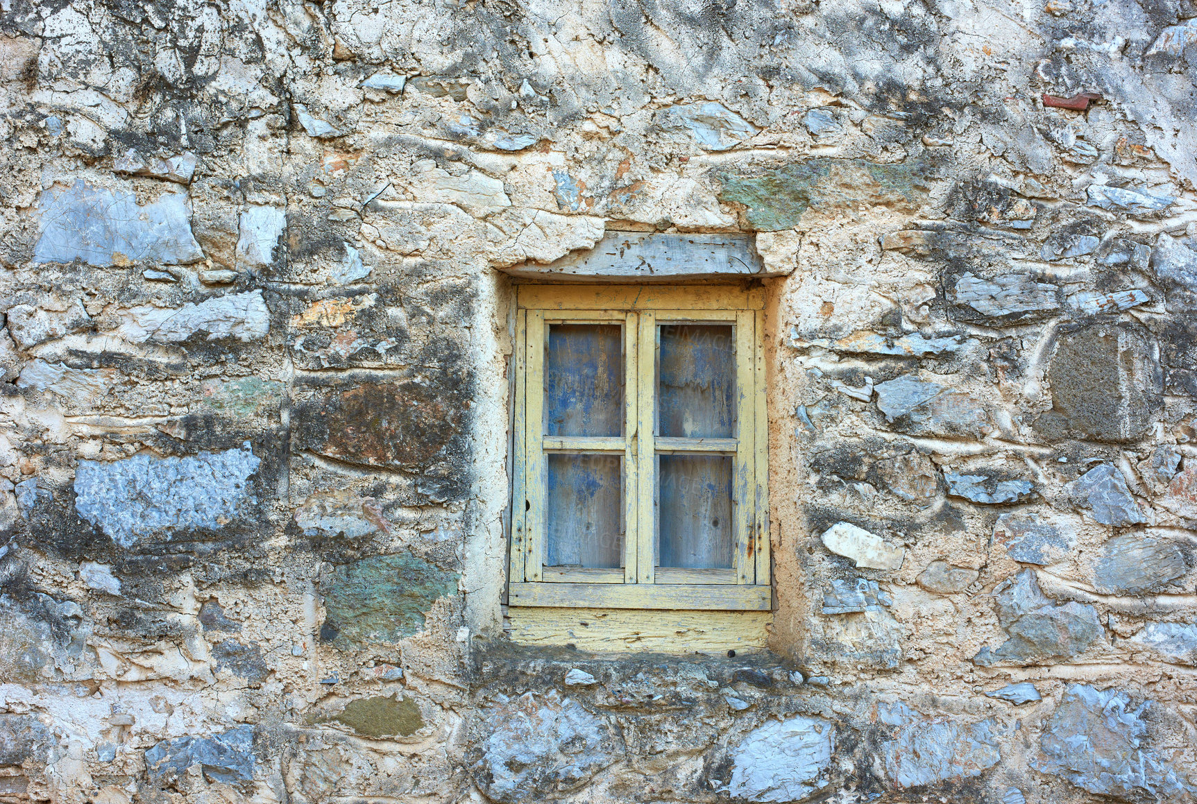 Buy stock photo Wooden window on an old rough stone wall farmhouse or ancient house. Vintage, rustic, old fashioned frame on historic village building and background. Architecture antique structure with background