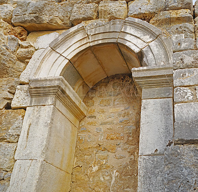 Buy stock photo Ancient arch in city ruins. Low angle of historic architecture and crumbling stone walls in tourist area. Excavated remains of damaged cultural building. Weathered antique home with traditional design