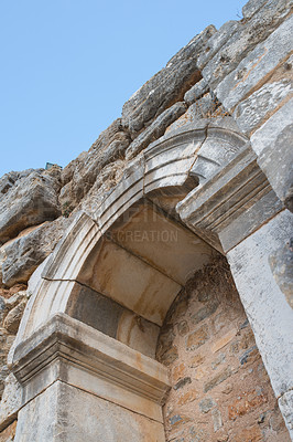 Buy stock photo Below view of ancient city ruins in a historical village. Traveling abroad and overseas for holiday, vacation, tourism. Low angle view of excavated stone remains of old cultural buildings with history