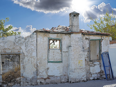 Buy stock photo A broken old house abandoned from poverty, unemployment on city outskirts. Empty rustic dilapidated home in ruins from economic crash, financial crisis. Exterior of destructed, neglected residence  