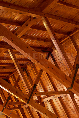 Buy stock photo Beautiful sturdy wood architecture of interior roof or ceiling inside a house or building. Wooden beams and natural building material used for interior. Stained wood used for room ceiling feature 