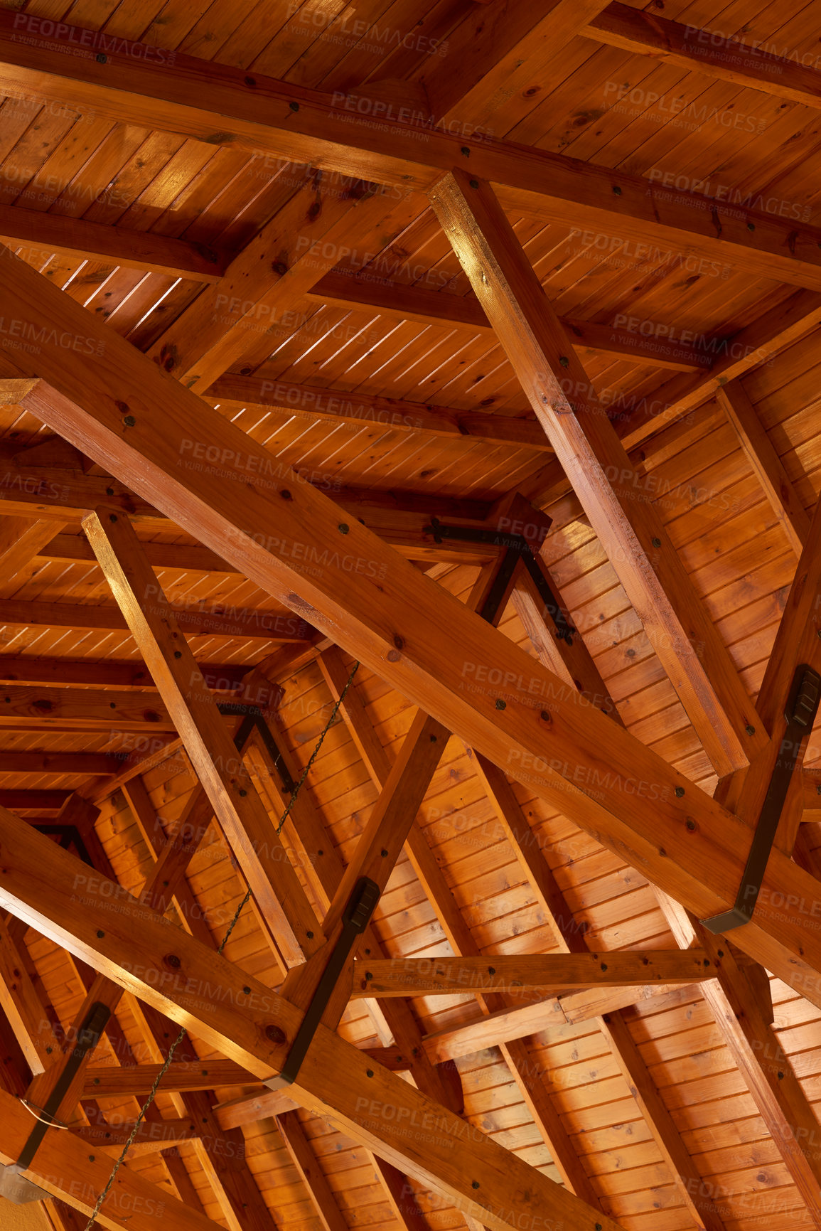 Buy stock photo Beautiful sturdy wood architecture of interior roof or ceiling inside a house or building. Wooden beams and natural building material used for interior. Stained wood used for room ceiling feature 