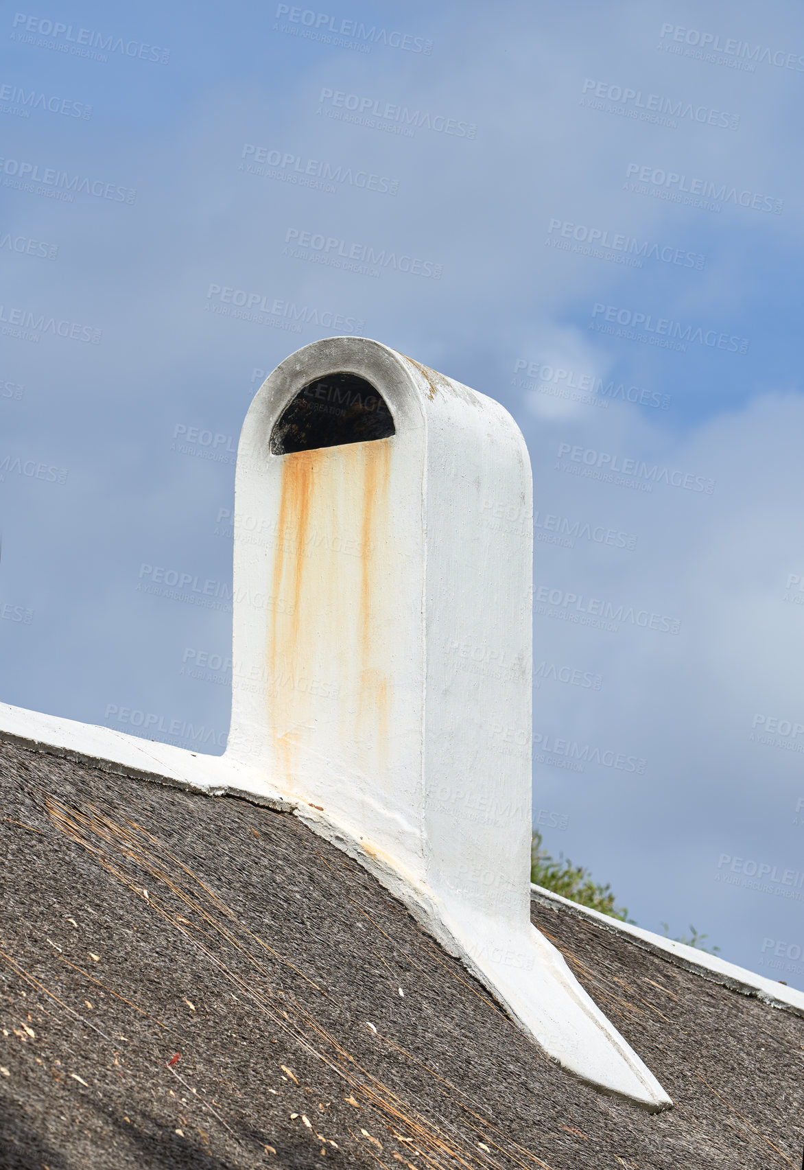 Buy stock photo Chimney designed on the roof of a house or building outside against a cloudy sky background with copyspace. Old, dirty escape chute on rooftop exterior for fireplace or oven smoke and ventilation