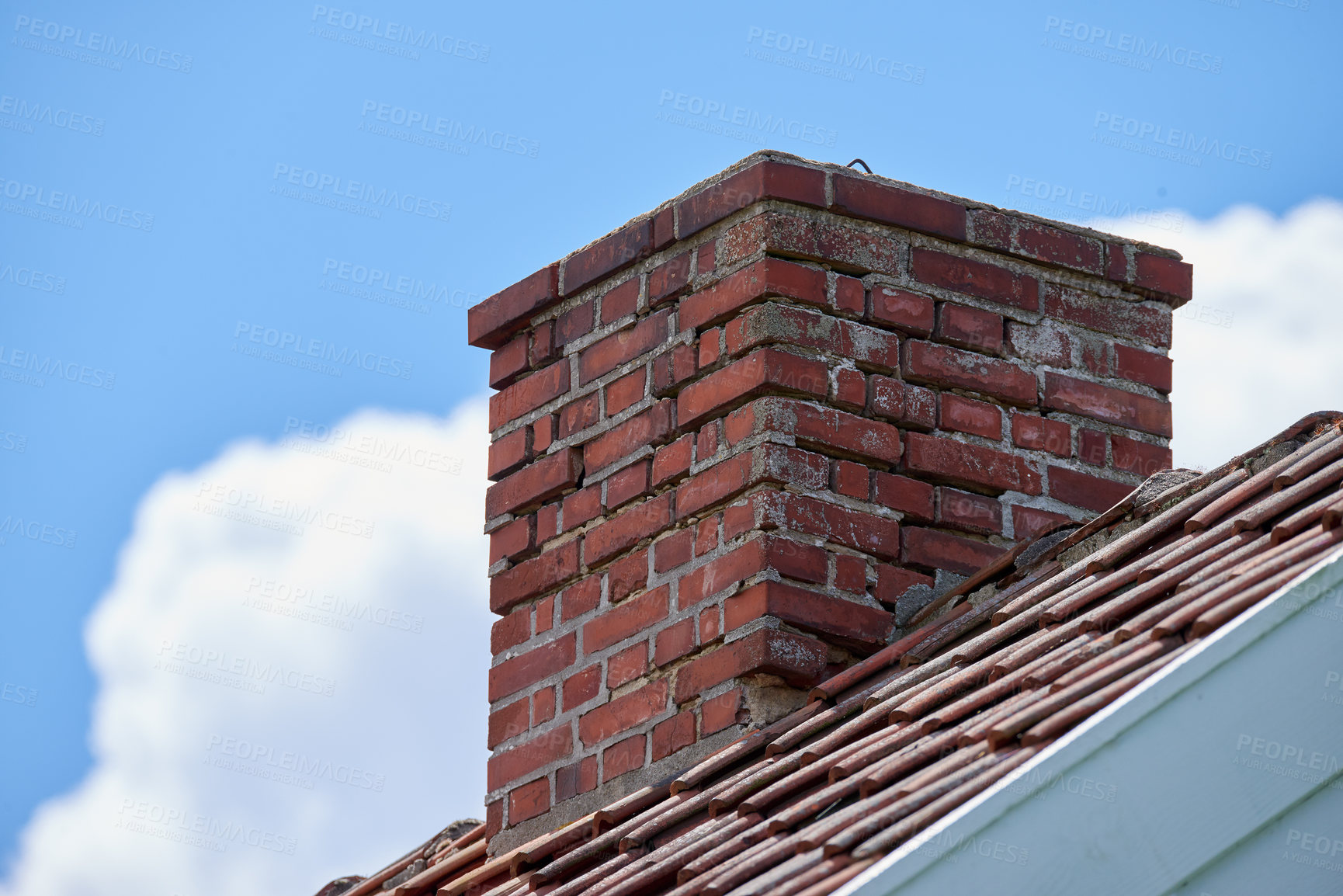 Buy stock photo Red brick chimney designed on house roof building outside against blue sky and clouds background. Construction of exterior architecture of escape chute built on rooftop for fireplace smoke and heat