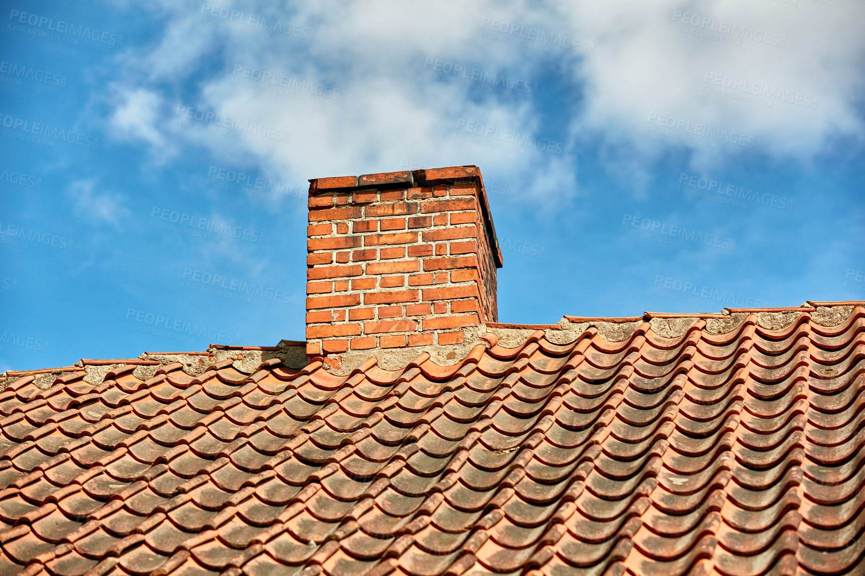 Buy stock photo Red brick chimney designed on the roof of residential house or building outside against a cloudy sky background with copyspace. Air vent construction for the release of smoke and heat from fireplace