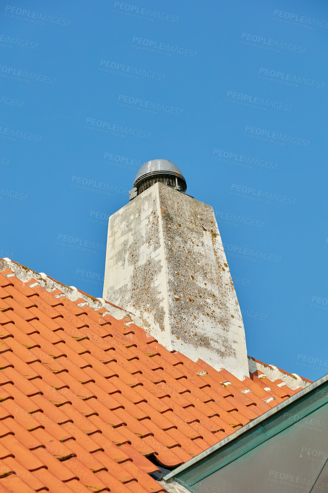 Buy stock photo Concrete chimney designed on slate house roof or building outside against clear blue sky background, copyspace. Construction of exterior escape chute built on rooftop for fireplace smoke and heat