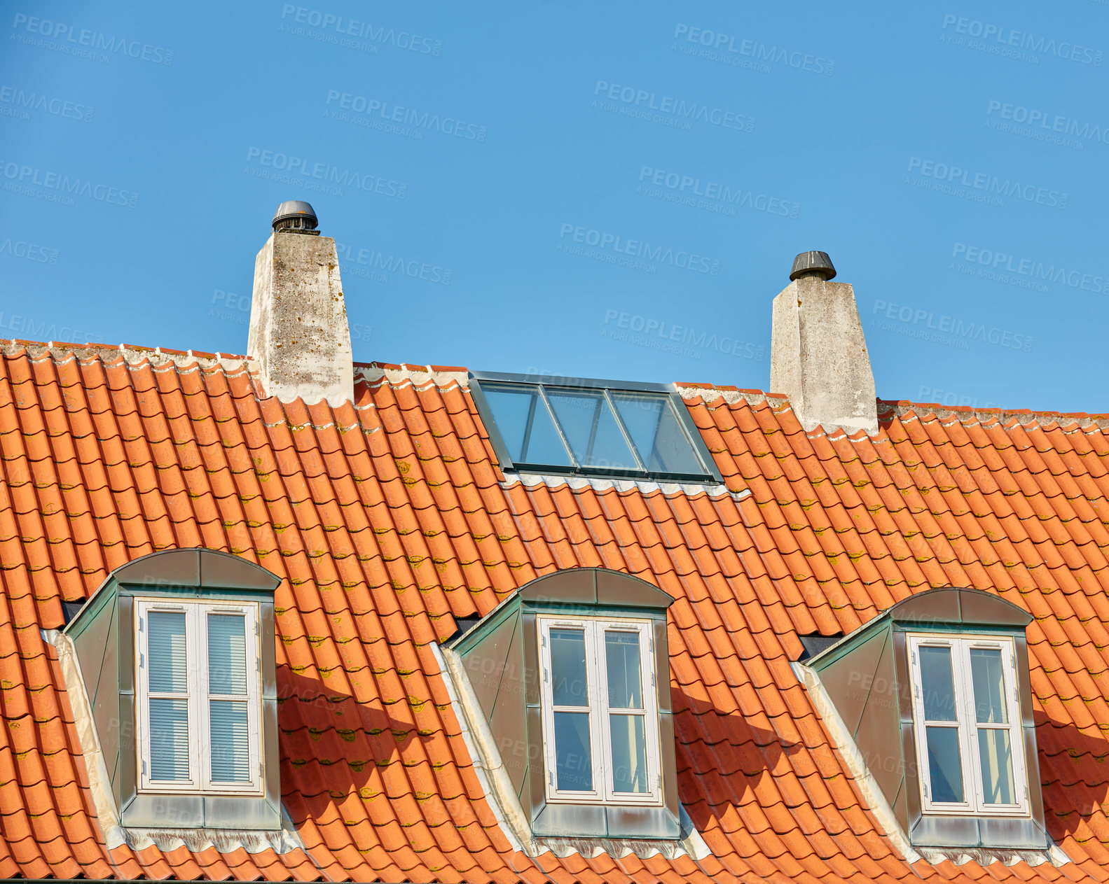 Buy stock photo Chimney chutes, windows and sunroof skylight designed on house building outside against blue sky background. Construction of exterior architecture on rooftop for fireplace escape and natural sunlight