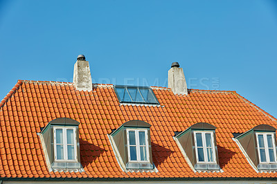 Buy stock photo Chimney chutes, windows and sunroof skylight designed on house building outside against blue sky background. Construction of exterior architecture on rooftop for fireplace escape and natural sunlight