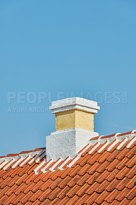 Buy stock photo Brick chimney designed on roof of house building outside against blue sky background with copyspace. Construction of exterior architecture of escape chute built on rooftop for fireplace smoke and heat