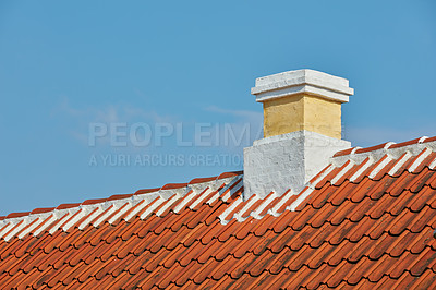 Buy stock photo Brick chimney designed on slate roof of house building outside against blue sky background. Construction of exterior architecture of escape chute built on rooftop for fireplace smoke and heat