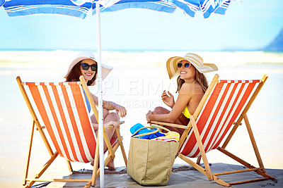 Buy stock photo Portrait of two beautiful young women eating an ice cream at the beach