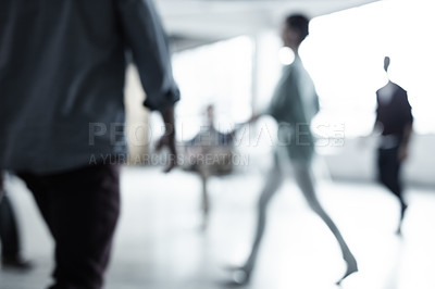 Buy stock photo Cropped shot of a group of businesspeople walking through an office