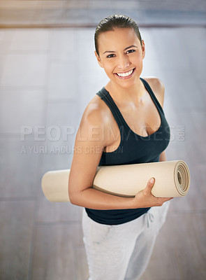 Buy stock photo Cropped portrait of a young woman carrying her exercise mat on the way to yoga