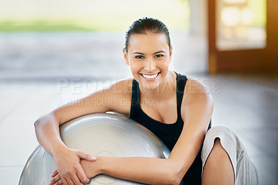 Buy stock photo Cropped portrait of a young woman sitting against her exercise ball