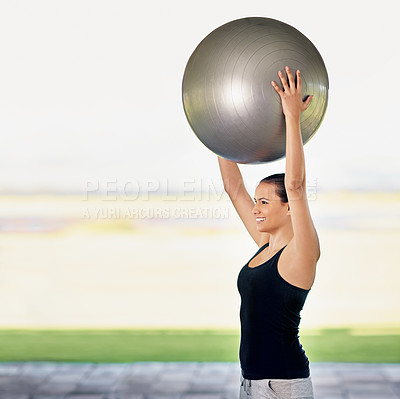 Buy stock photo Cropped shot of a young woman working out with an exercise ball
