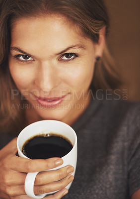 Buy stock photo Portrait of a young woman enjoying a cup of coffee at home