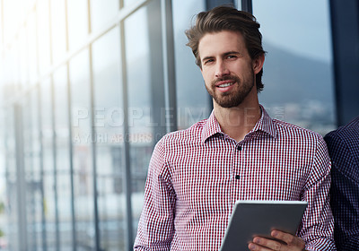 Buy stock photo Portrait of a young businessman using a digital tablet outside of an office building