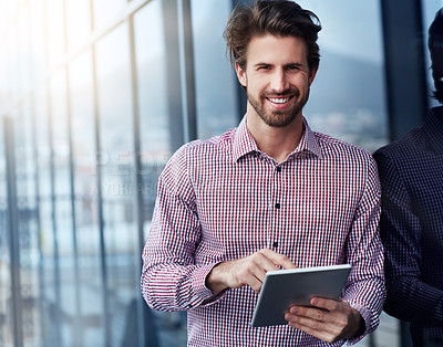 Buy stock photo Portrait of a young businessman using a digital tablet outside of an office building