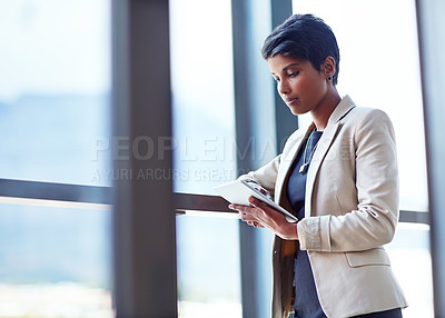Buy stock photo Tablet, mockup and research with a business woman leaning against a glass wall or window at the office. Technology, corporate and space with a young professional female employee working online