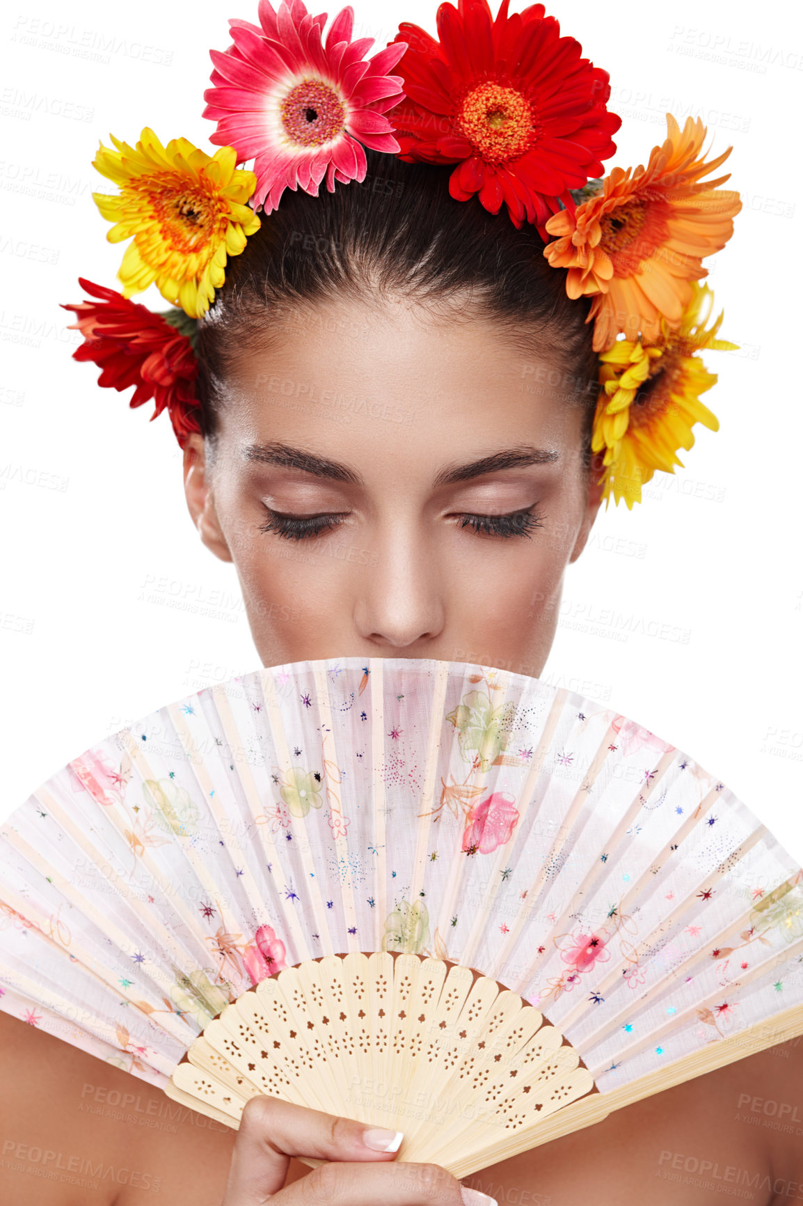 Buy stock photo Cropped shot of a beautiful young woman wearing a crown of flowers while holding a fan in front of her face