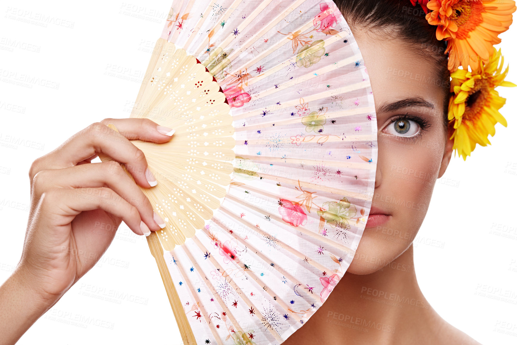 Buy stock photo Cropped portrait of a beautiful young woman wearing a crown of flowers while holding a fan in front of her face