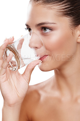 Buy stock photo Studio shot of a young woman taking a sip of water