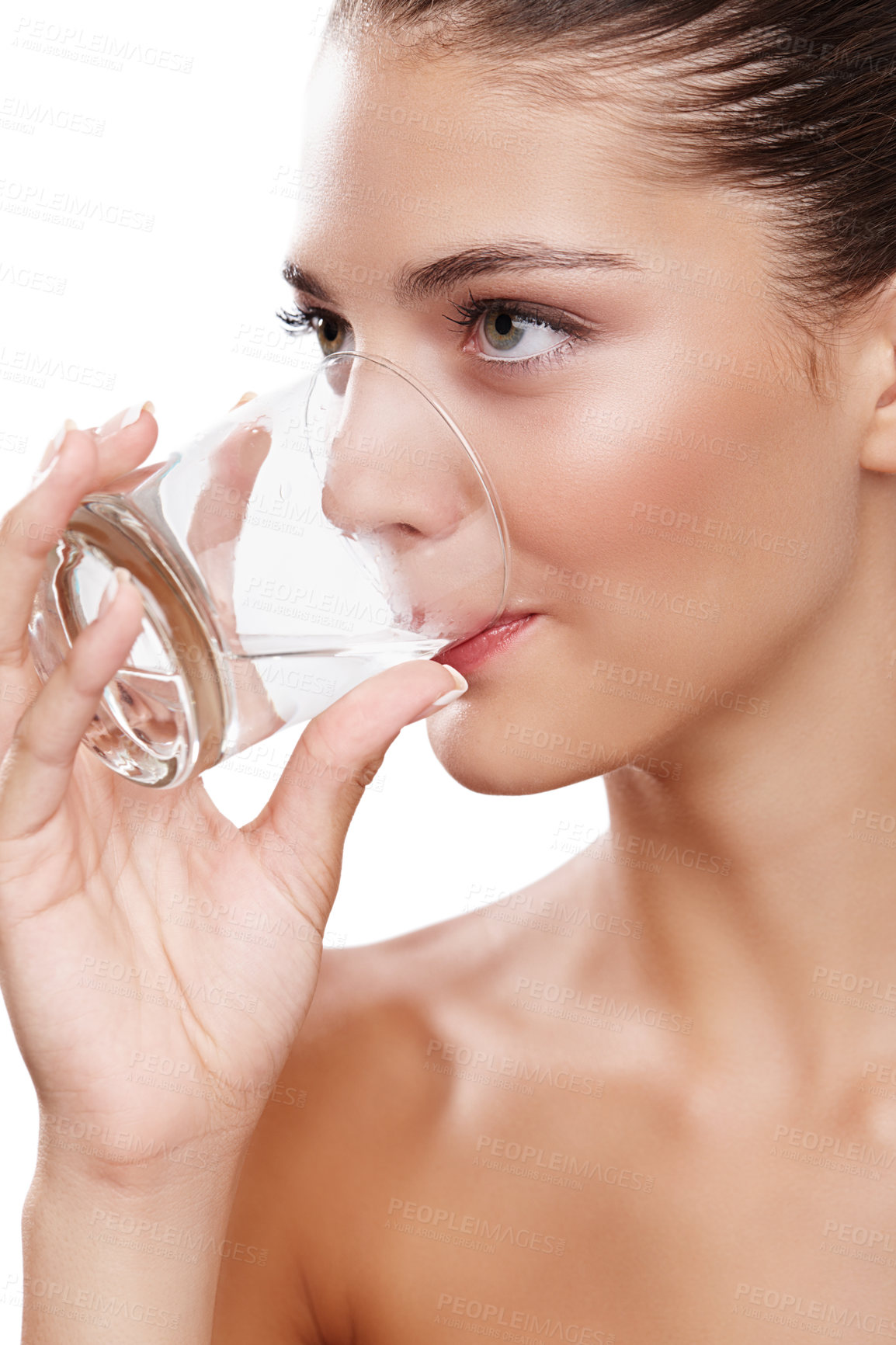 Buy stock photo Studio shot of a young woman taking a sip of water