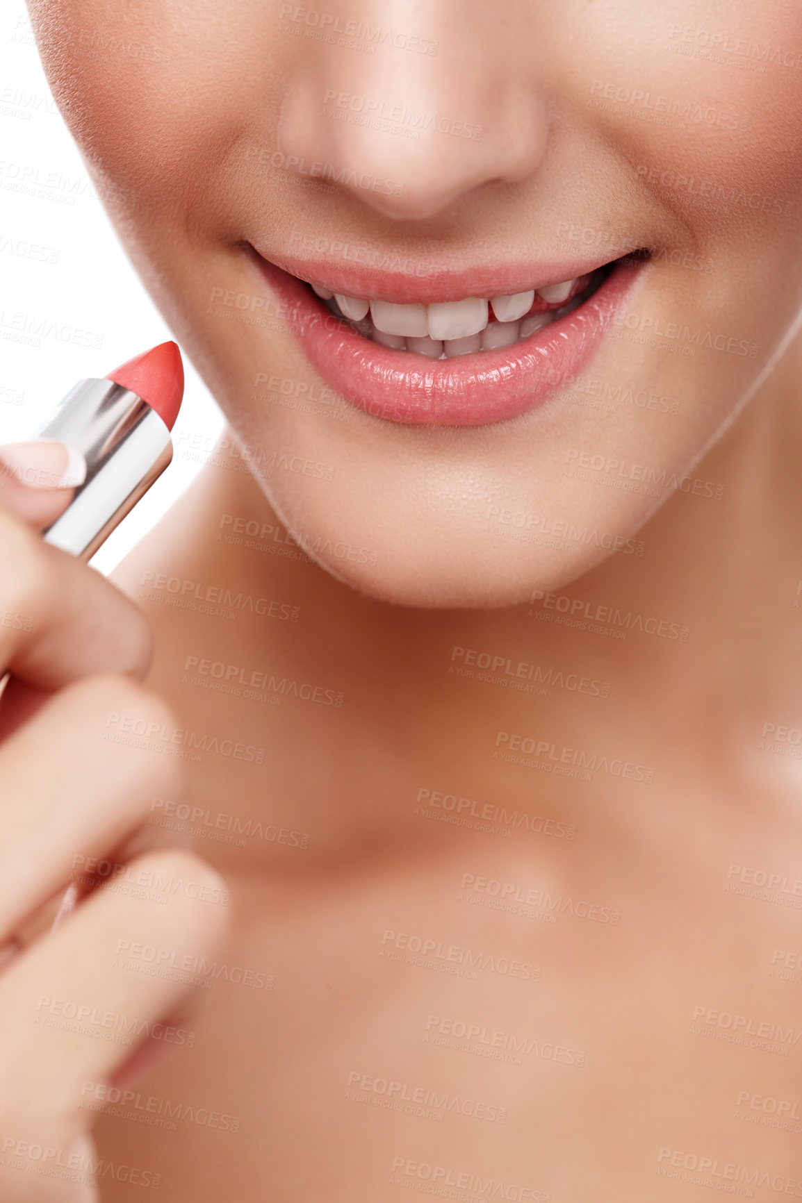 Buy stock photo Closeup studio shot of a beautiful young woman applying lipstick isolated on white