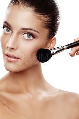 Buy stock photo Studio portrait of a beautiful young woman applying makeup isolated on white