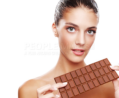 Buy stock photo Studio portrait of an attractive young woman holding a slab of chocolate