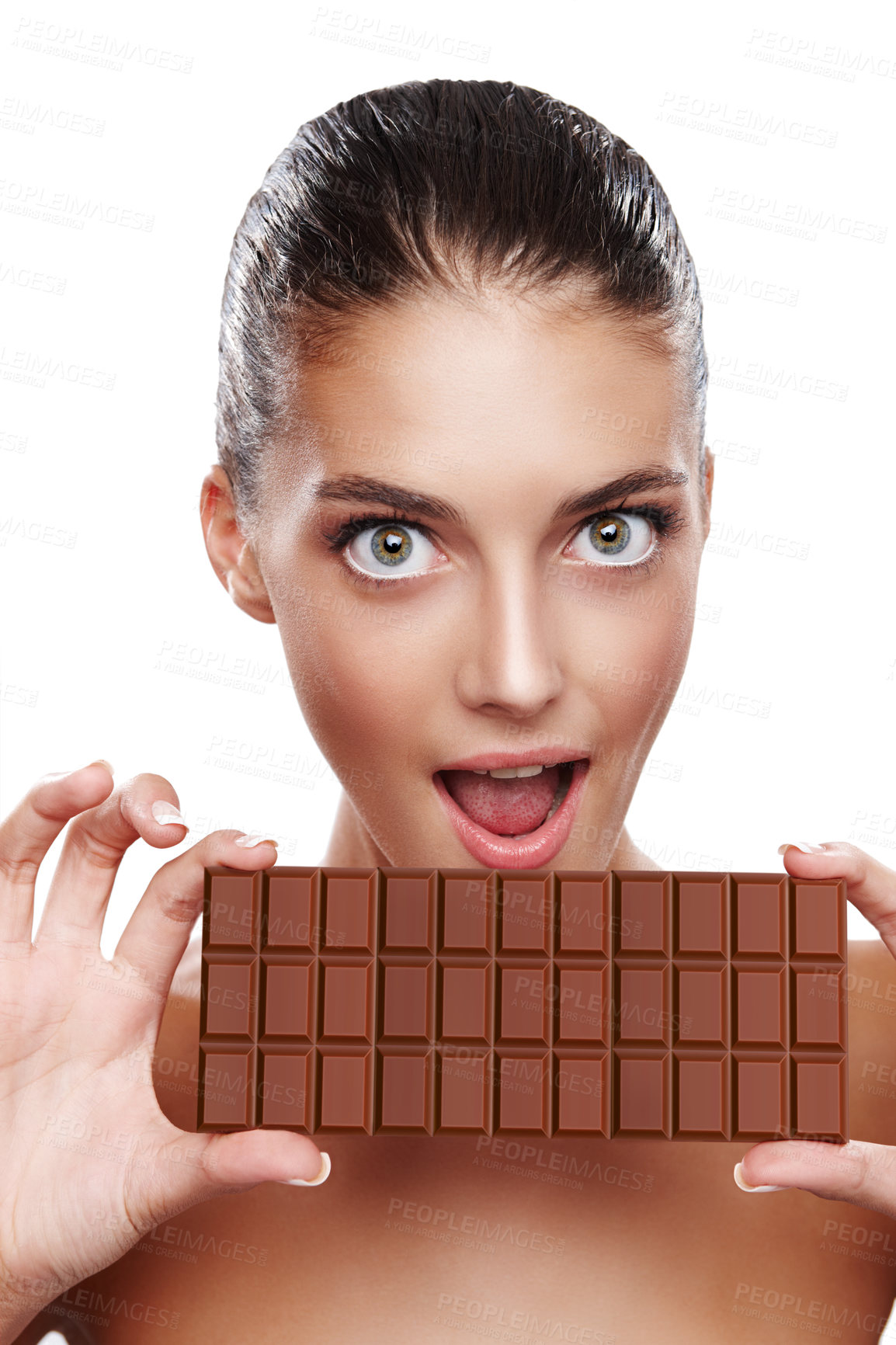 Buy stock photo Studio portrait of an attractive young woman about to bite into a slab of chocolate