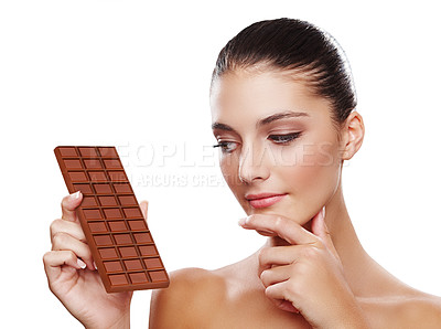 Buy stock photo Studio shot of an attractive young woman holding a slab of chocolate